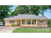 Charming single-story brick and stone home with welcoming front porch and lush landscaping at 318 W Peeler St, Salisbury, NC 28146