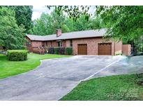 Charming brick home featuring a two-car garage and mature trees at 4004 Stillwater Ct, York, SC 29745
