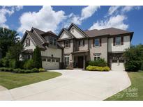 Attractive two-story home with a well-manicured lawn and a spacious driveway at 426 Kirkbride Ct, Fort Mill, SC 29715