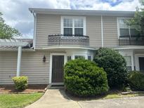 Charming townhome with a traditional exterior, dark brown front door, and manicured landscaping at 502 Heritage Pkwy, Fort Mill, SC 29715
