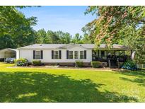 Charming single-story home with well-maintained lawn, white siding, black shutters, and inviting front porch at 5425 Creek Run Ct, Kings Mountain, NC 28086