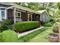 Charming home with a covered porch, tidy landscaping, and a welcoming entrance at 5916 Indian Brook Dr, Matthews, NC 28104