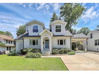 Charming two-story home with a painted brick exterior, dormers, and attached carport at 2333 Greenland Ave, Charlotte, NC 28208