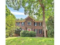 Charming brick two-story home with manicured lawn and lush greenery, enhancing its curb appeal at 3730 Monique Ln, Charlotte, NC 28210