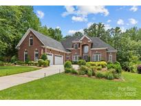 Stunning brick home featuring a three-car garage and beautiful landscaping at 4263 Rambling Rose Ln # 23, Rock Hill, SC 29732