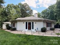 Charming home featuring red shutters, a well-kept lawn, and a cozy pathway to the front door at 5017 Celeste Ct, Charlotte, NC 27609