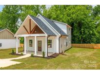 Charming home featuring a covered front porch with stylish beams and freshly landscaped yard at 512 North Mulberry St, Cherryville, NC 28021