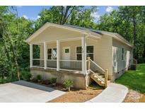 Charming home with a welcoming porch, manicured landscaping, and beautiful curb appeal at 54 Reed Ne St, Concord, NC 28025