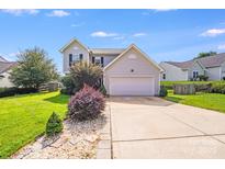 Charming two-story home features manicured lawn, neutral siding, and a convenient two-car garage at 6922 Brandon Chase Ln, Concord, NC 28025