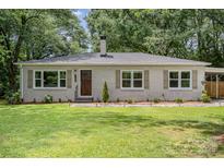 Charming brick ranch home with manicured lawn and mature trees at 1006 Home Trl, Gastonia, NC 28052