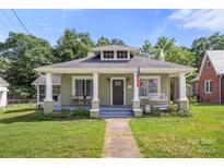 Charming bungalow home featuring a welcoming front porch and well-maintained lawn at 124 Marion St, Clover, SC 29710
