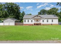 Charming single-story home features white siding, a welcoming front porch, and a spacious lawn at 1593 Bloomfield Rd, Rock Hill, SC 29732