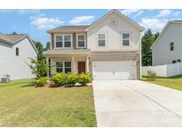 Charming two-story home featuring a well-manicured lawn and a two-car garage at 1691 Ashley Lynn Ct, Stanfield, NC 28163