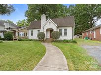 A well-maintained home with a brick chimney, manicured lawn, and charming curb appeal at 2130 Chesterfield Ave, Charlotte, NC 28205