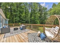 Inviting outdoor wooden deck features stylish seating and peaceful wooded views for relaxing or entertaining at 2222 19Th Ne Ave, Hickory, NC 28601