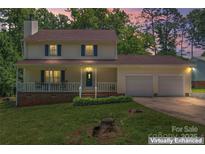 Charming two-story home with a cozy front porch and a well-maintained lawn at 308 Home Rd, Salisbury, NC 28147