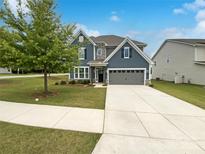 Charming two-story home featuring a well-manicured lawn and a two-car garage at 3090 Bridgewater St, Lancaster, SC 29720