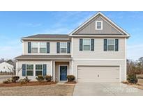 Two-story home with blue shutters, a blue door, and a two-car garage at 4060 Beacon Ave # 148, Monroe, NC 28110