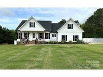 Charming two-story modern farmhouse with black shutters, covered porch, and a well-manicured lawn at 4282 Brandy Creek Ct, Clover, SC 29710