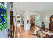 Spacious foyer featuring hardwood floors, staircase, and entry to the dining room at 5056 Crandon Rd, Fort Mill, SC 29707