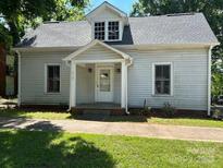 Charming home with covered entryway, neutral siding, and well-maintained lawn at 517 Western Ave, Statesville, NC 28677