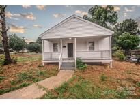Charming home with a quaint front porch, freshly painted white exterior, and inviting curb appeal at 601 N Johnson St, Monroe, NC 28112