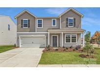 Charming two-story home with gray siding, a two-car garage, and well-manicured front yard at 6331 Fairfax Ct, Maiden, NC 28650