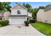 Charming two-story home with a white exterior, attached garage, and well-manicured landscaping at 6340 Green Vista Ct, Charlotte, NC 28212