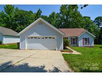 Charming single-story home featuring an attached garage, manicured lawn, and inviting curb appeal at 676 Rebecca Jane Dr, Mooresville, NC 28115