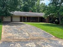 Charming one-story brick home with a long driveway and mature trees at 715 Sunridge Dr, Lincolnton, NC 28092
