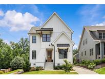 Charming two-story home featuring crisp white siding, black window trim, and a welcoming front porch at 113 Prince St, Belmont, NC 28012