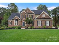 Charming brick two-story home features a well-manicured lawn and inviting front entrance at 116 Ivy Hollow Ln, Mooresville, NC 28117
