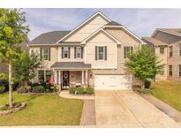 Charming two-story brick home featuring a well-manicured lawn and inviting front porch perfect for relaxation at 1178 Arges River Dr, Fort Mill, SC 29715