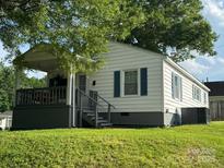 Charming single-story home with covered porch, white siding, blue shutters, and a well-maintained lawn at 123 E Farmview St, Gastonia, NC 28054
