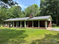 Charming brick home with a covered front porch and a well-maintained lawn at 5200 E Us 70 Hwy, Catawba, NC 28609