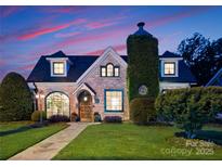 Charming brick home with manicured lawn, stone pathway, and unique ivy-covered chimney detail at 117 N Central Ave, Belmont, NC 28012
