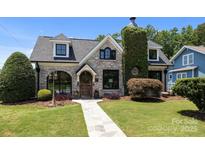 Charming brick home with a lush, landscaped front yard and inviting stone pathway at 117 N Central Ave, Belmont, NC 28012