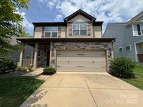 Charming two-story home with a stone facade and inviting front porch at 1314 San Gabriel Ave, Charlotte, NC 28214