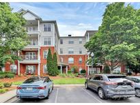 Beautiful condo complex with brick facade, manicured landscaping, and ample parking at 14451 San Paolo Ln, Charlotte, NC 28277