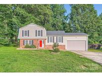 Charming two-story home with a bright red front door, well-maintained lawn, and a one-car garage at 1506 Union New Hope Rd, Gastonia, NC 28056