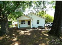 Charming bungalow-style home with a covered front porch and well-maintained yard with mature shade trees at 201 W 19Th St, Kannapolis, NC 28081