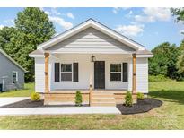 Charming home featuring a wood porch, craftsman columns, and dark shutters at 210 Marshall St, Rock Hill, SC 29730