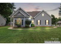 Charming single-story home features a well-manicured lawn and traditional architectural details at 219 Mccord St, Charlotte, NC 28216