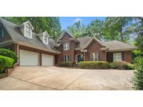 Charming brick home with a well-maintained front yard, a three-car garage, and a spacious driveway at 23 Tanglewood Rd, Clover, SC 29710