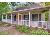 Inviting front porch with white railing and columns, complemented by lush landscaping at 25056 Timberlake Dr, Fort Mill, SC 29708