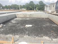 New home foundation under construction in a community with modern townhomes at 2927 Herringbone Rd # 41, Charlotte, NC 28208
