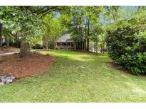 Large grassy front yard with shade trees leading up to the covered front porch of the home at 3092 Hitching Post Ln, Rock Hill, SC 29732