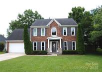 Traditional two-story brick home with well-manicured lawn and attached two-car garage at 3905 Brittany Ct, Indian Trail, NC 28079