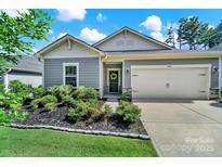 Charming single-story home featuring a well-manicured lawn, gray siding, and an attached two-car garage at 4420 Bright Rd, Charlotte, NC 28214