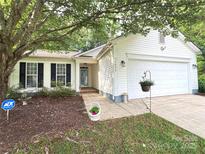 Charming single-Gathering home featuring white siding, a well-manicured lawn, and a two-car garage at 5434 Starflower Dr, Charlotte, NC 28215